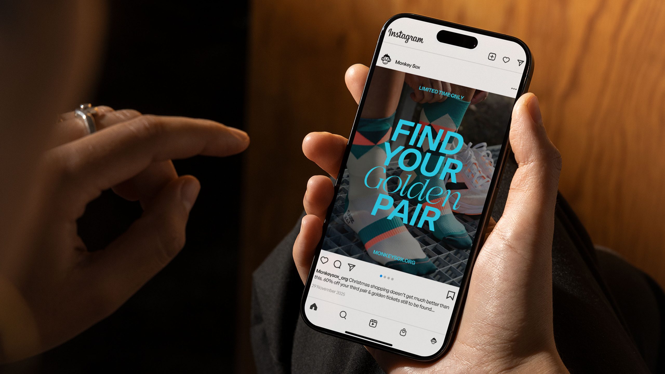 Someone holding a phone looking at an instagram post for black friday